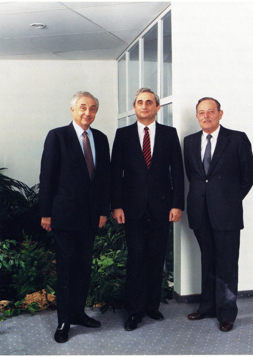 Three people standing together, including Uzia Galil, Emmanuel Gill, and Beny Peled